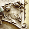 Bassorilievo che allude alla definizione galileiana del moto parabolico dei proietti sulla facciata del Palazzo dei Cartelloni, Firenze.