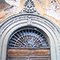 Portone d'ingresso con decorazioni, Centro Documentazione Tutela e Valorizzazione del Patrimonio Culturale e Scientifico della Sanit� Pubblica, Pisa.