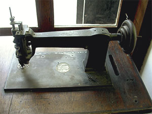Historical sewing machine on display in the old exhibit of the Luigi Lombard Museum, Stia.
