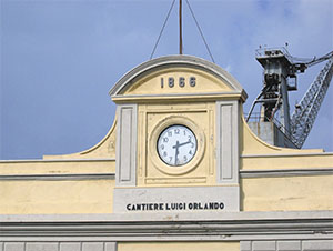 Clock and year of foundation (1866) on the facade of the "Fratelli Orlando" Shipyard, Livorno.