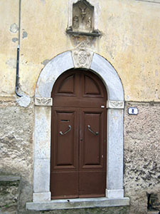 Door with coat of arms and decorations, Stazzema.