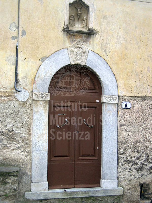 Door with coat of arms and decorations, Stazzema.