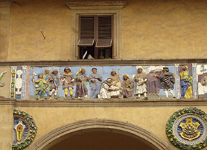 "Lodge the pilgrims", Della Robbian polychrome frieze on the ancient faade of the Hospital del Ceppo, glazed terracotta,Santi Buglioni, 1526-28, Pistoia.