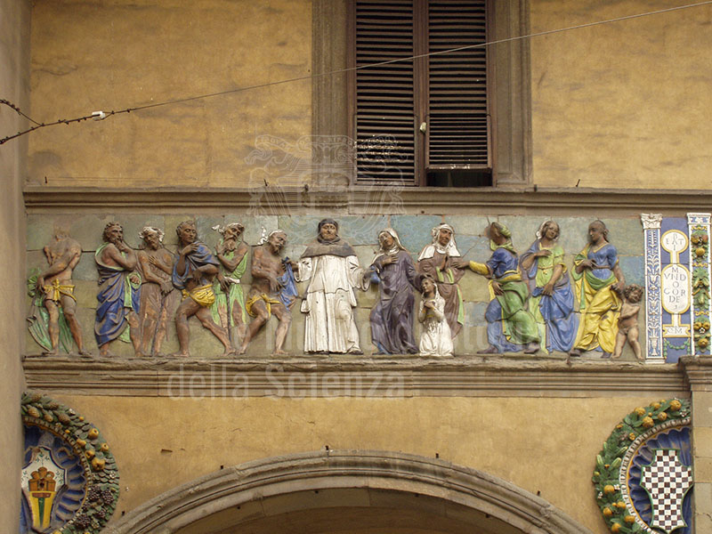 "Dress the naked and assist the widows", Della Robbian polychrome frieze on the ancient faade of the Hospital del Ceppo, glazed terracotts,Santi Buglioni, 1526-28, Pistoia.