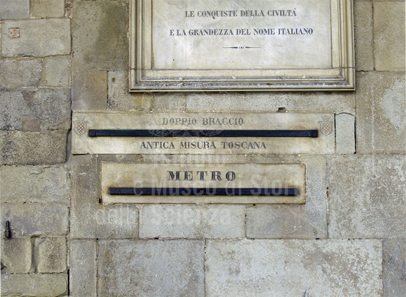 Unit di misura a confronto (doppio braccio e metro) nel portico del Palazzo Comunale, Pistoia.