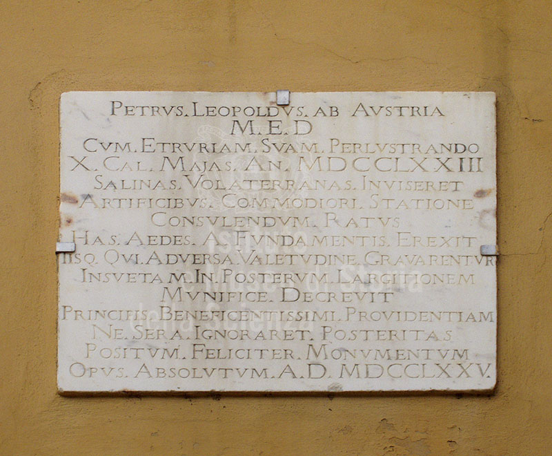 Commemorative stone tablet on the building of the State salt mines at Saline di Volterra.