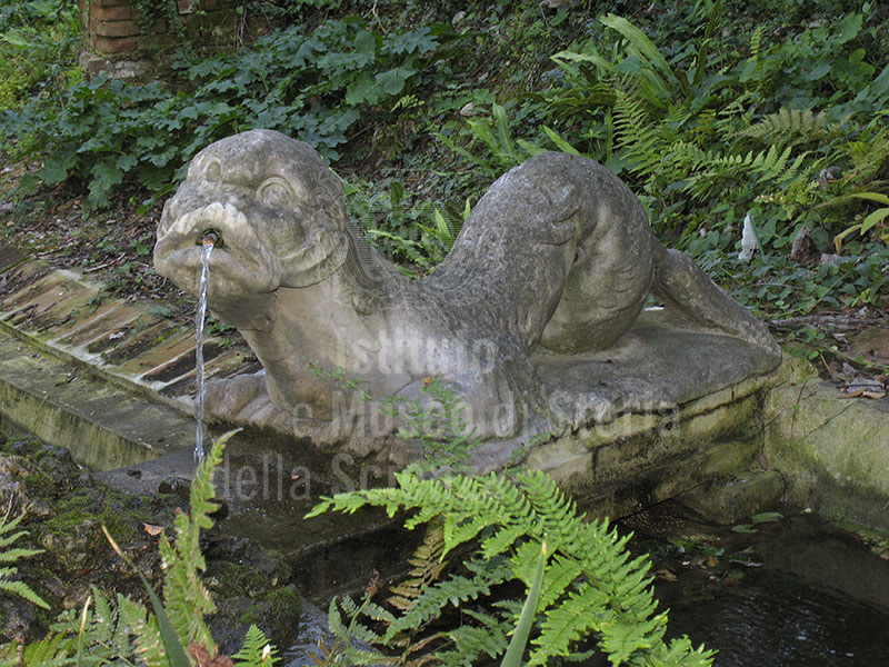 Garden of Palazzo Mozzi Bardini, Florence: stone statue used as fountain in the dragon canal.