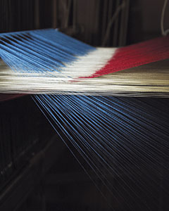 Weaving yarn on a loom, Fondazione Arte della Seta Lisio, Florence.