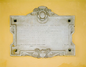 Stone tablet with inscription in the courtyard of the United Hospitals of Santa Chiara, Pisa.