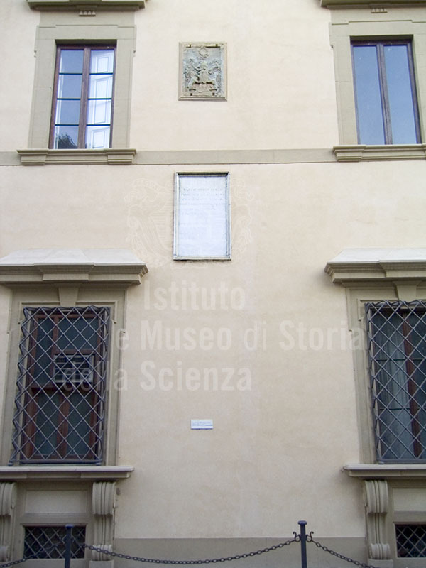Facade of Palazzo della Gherardesca with coats of arms, plaques and the indication of the water level during the 1966 flood, Florence.