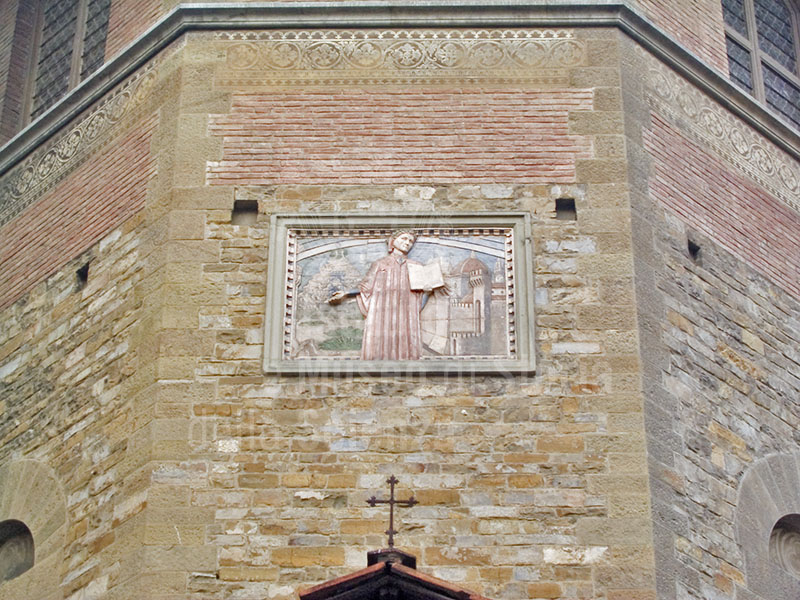 Bas-relief on the Palazzo of the Wool Merchants Guild depicting Dante.  In the background, note the Walls of Florence and several major buildings, including Brunelleschi's Dome and the tower of Palazzo Vecchio.