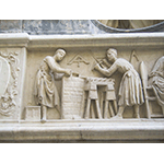 Tabernacle of the Four Crowned Saints, detail of the bas-relief depicting two saints at work:  one builds a wall, while the other holds a drill and works on a column, Nanni di Banco, 1408, Orsanmichele, Florence.
